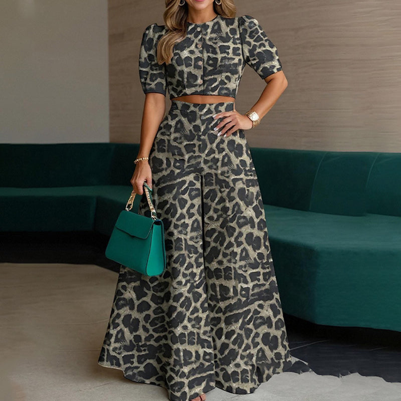 Set med elegant kort topp med puffärmar och byxor med vida ben