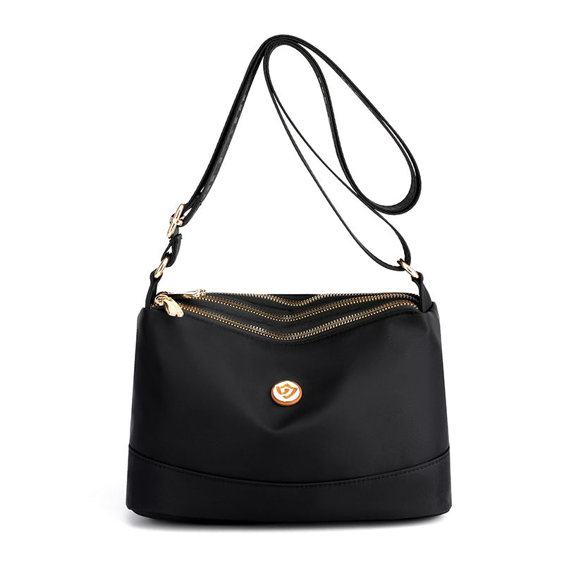 Minimalistisk axel- och crossbodyväska i nylon med stor kapacitet