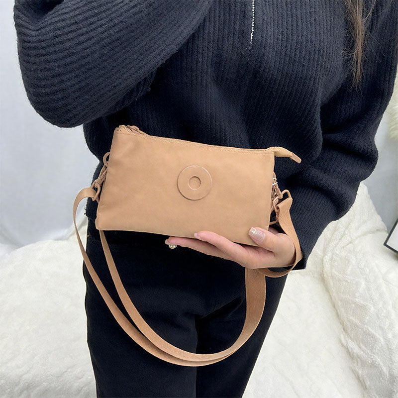 Modig zip-crossbody-väska