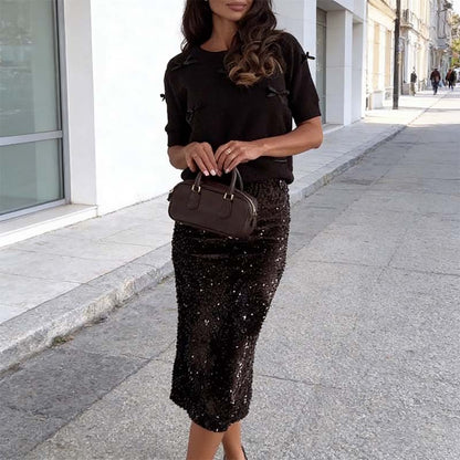 Elegant topp med rosettdetalj och paljettkjol