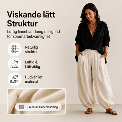 Damset med lös skjorta och draperade byxor