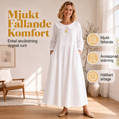 Damig löst sittande långärmad maxiklänning med fickor