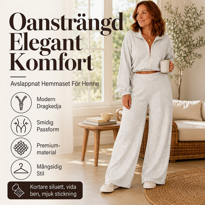 Damset med kort dragkedja-tröja och vida byxor